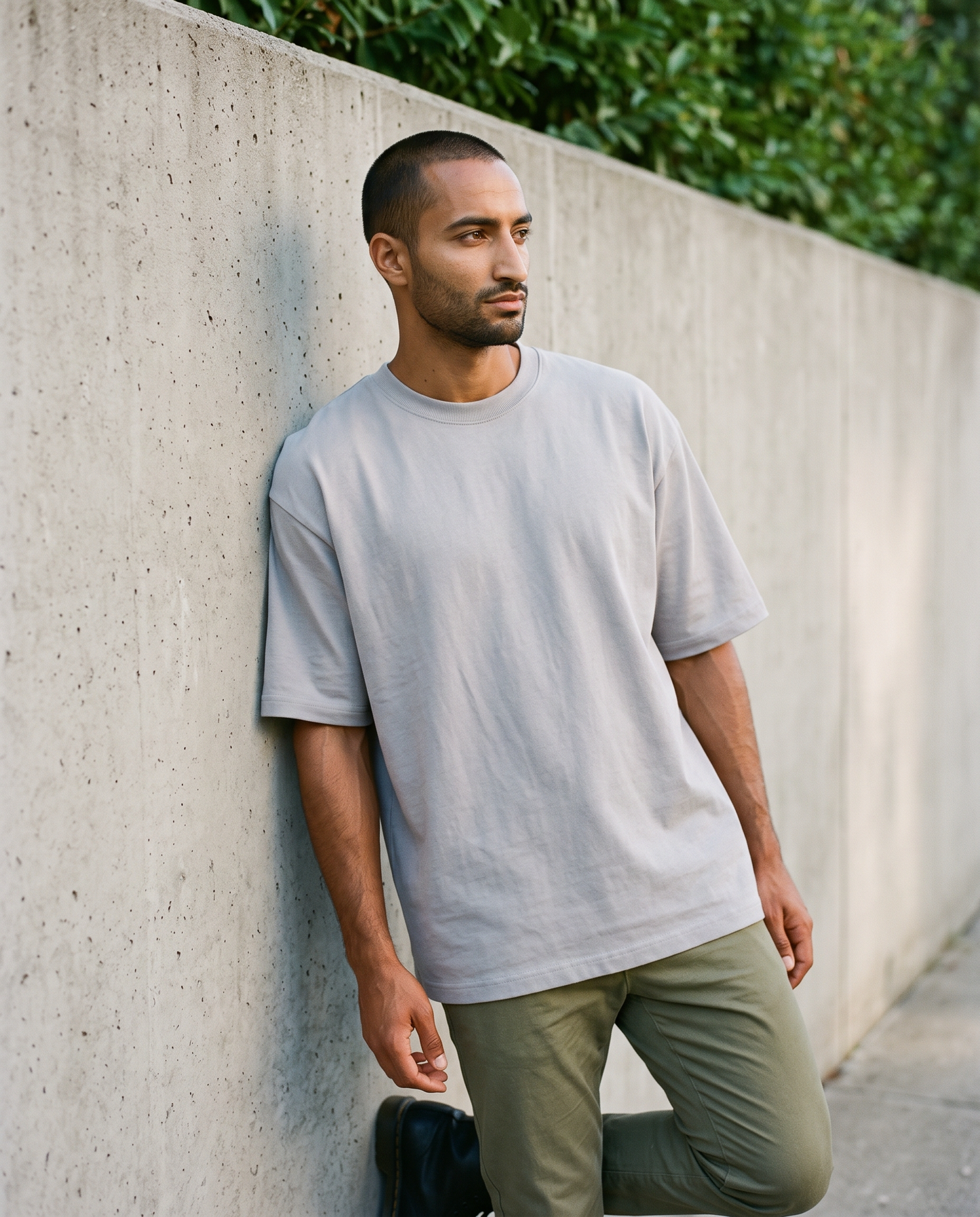 ZIL Gray Oversized Tee on model, wall, loose fit