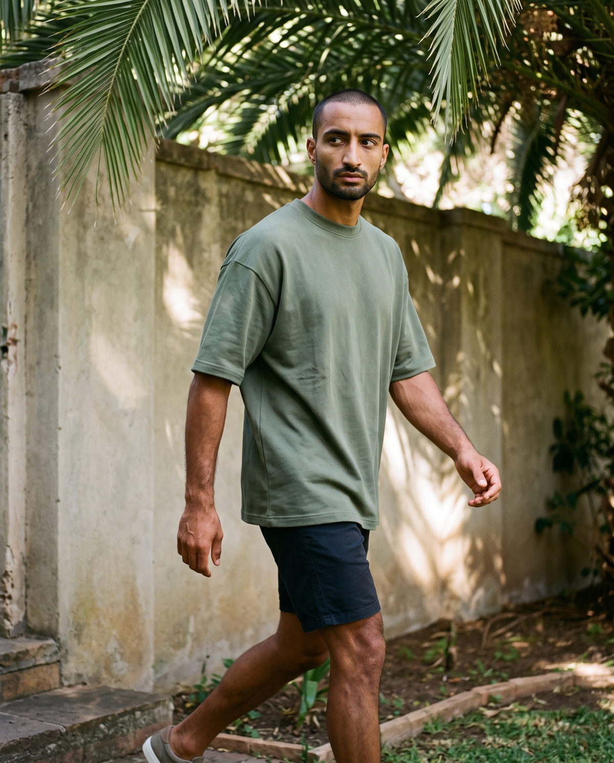 ZIL Army Green Oversized Tee on model, walking, loose fit