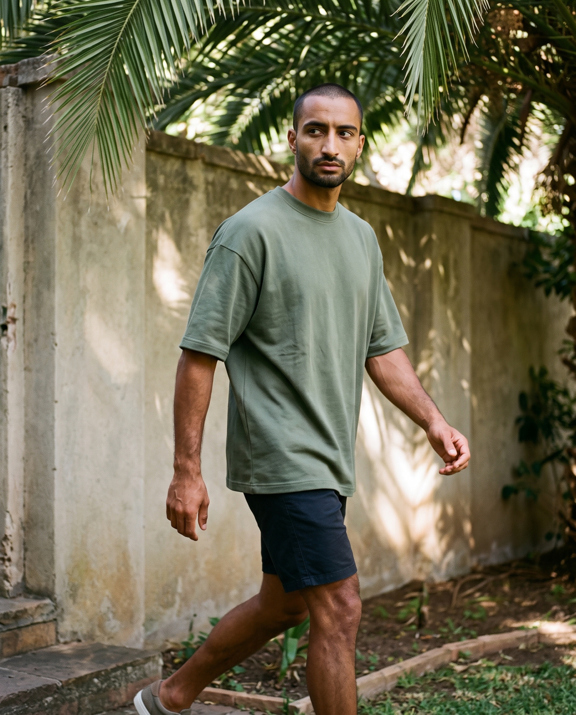 ZIL Army Green Oversized Tee on model, walking, loose fit